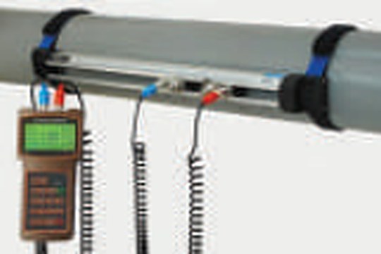 Clamp-on ultrasonic flow meter fitted to a pipe