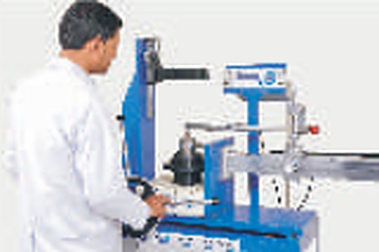 Engineer operating a torque and force calibration machine